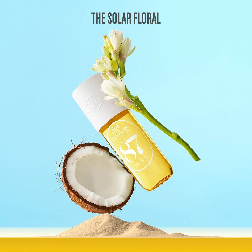Bottle of coconut oil with a flower on a blue background, featuring 'The Solar Floral' brand.