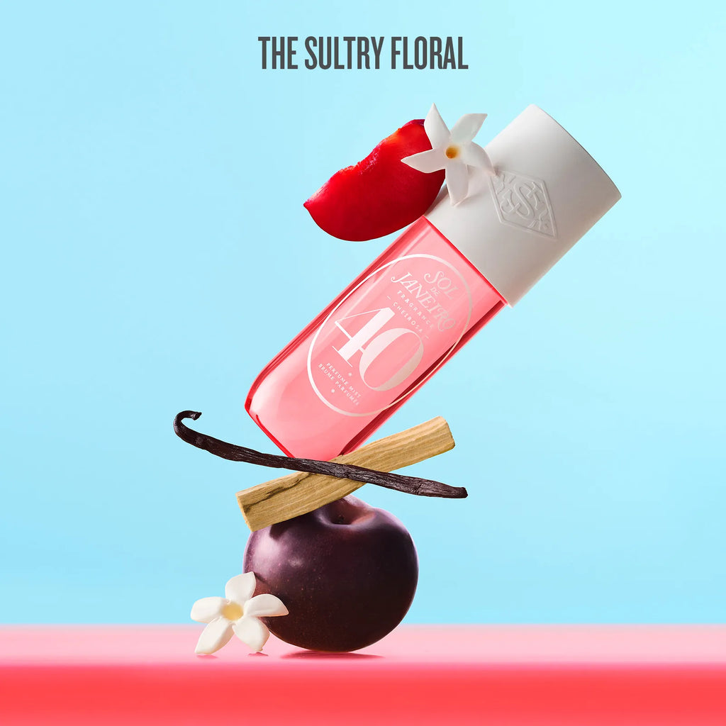 Pink bottle with white cap on a red fruit and vanilla bean against a light blue background, labeled 'The Sultry Floral'.