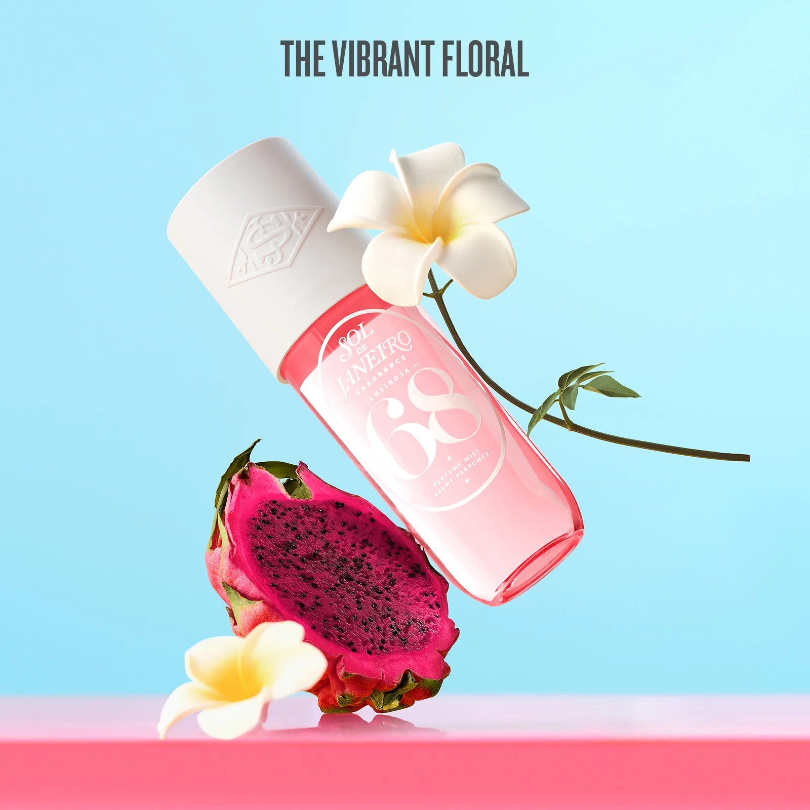 Pink perfume bottle with dragon fruit and flowers on a light blue background