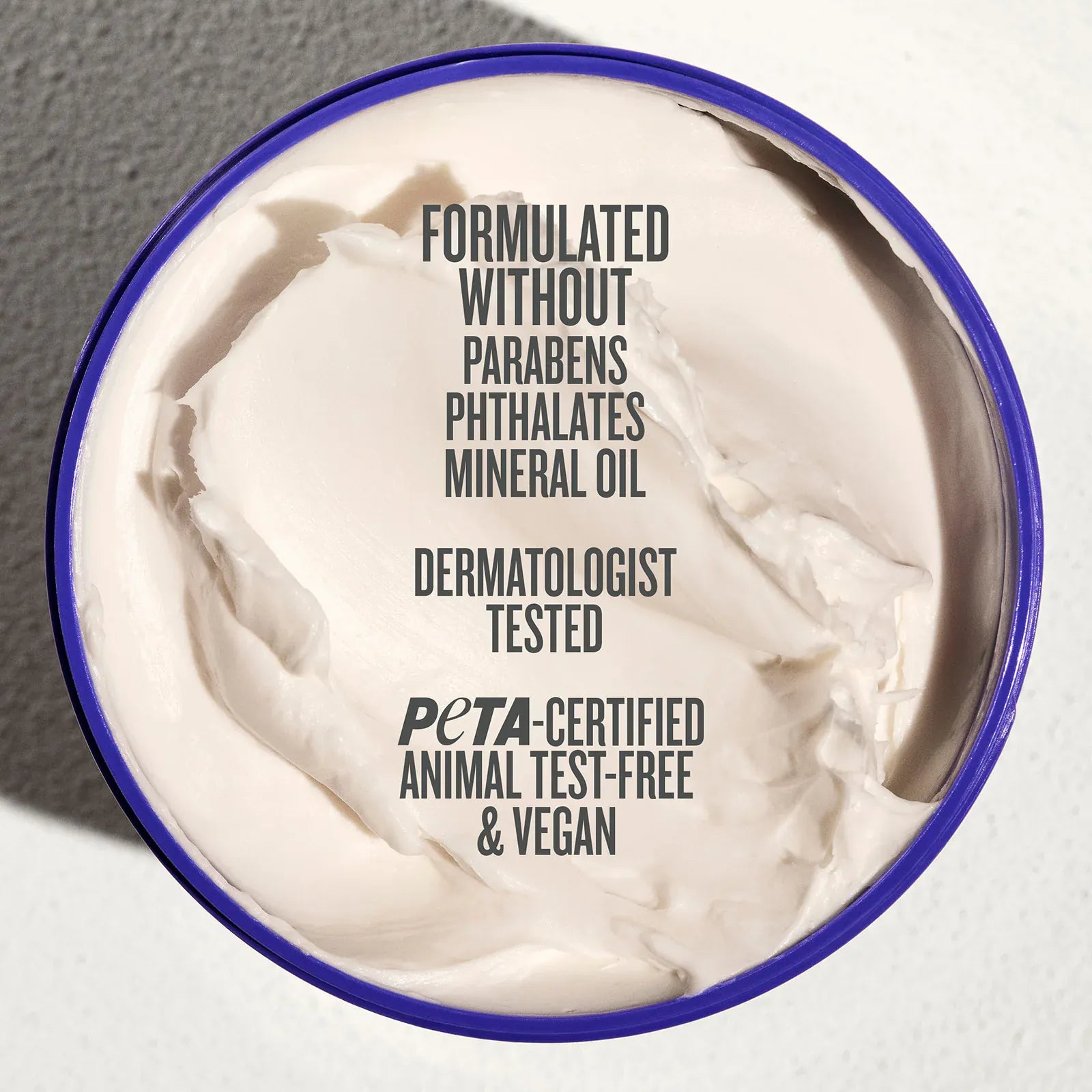 Jar of cream with certification text on a neutral background