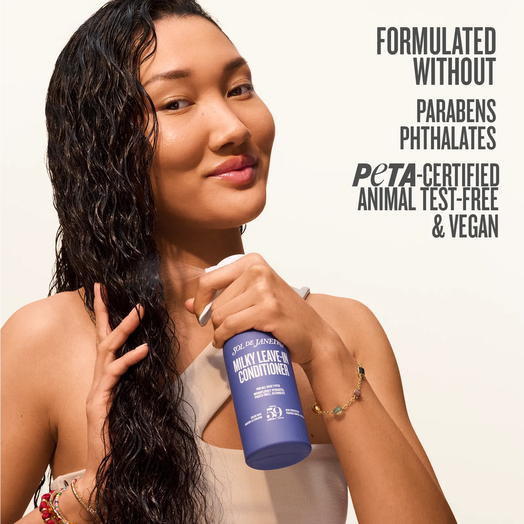 Woman holding a blue conditioner bottle with text about product features on a beige background