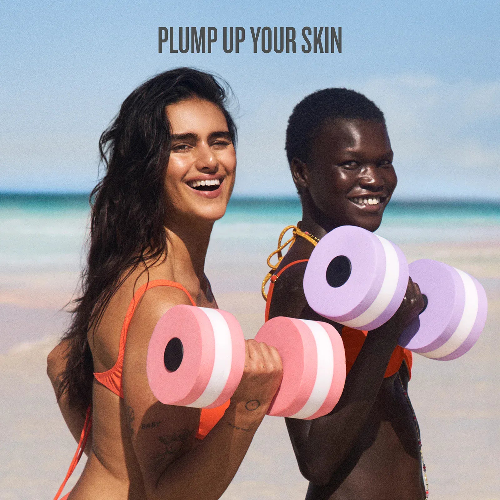 Two people on a beach holding pink and purple dumbbells with text 'Plump Up Your Skin'.
