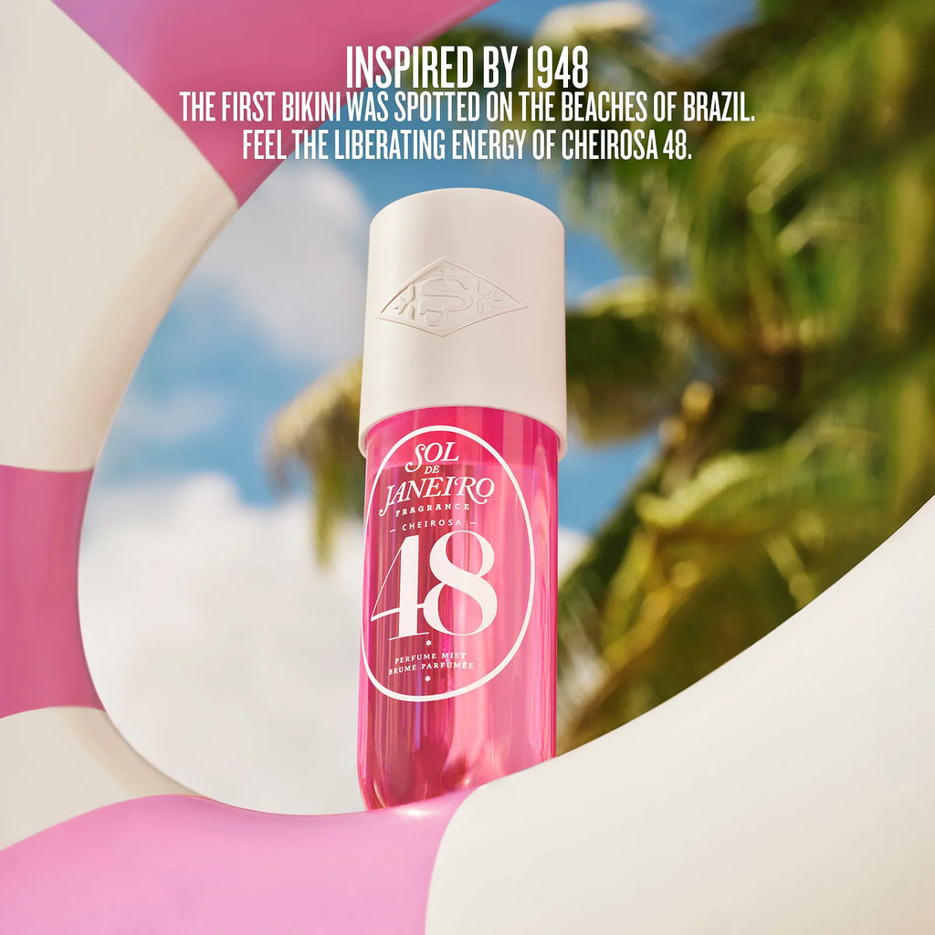 Pink bottle with white cap on a blurred beach background