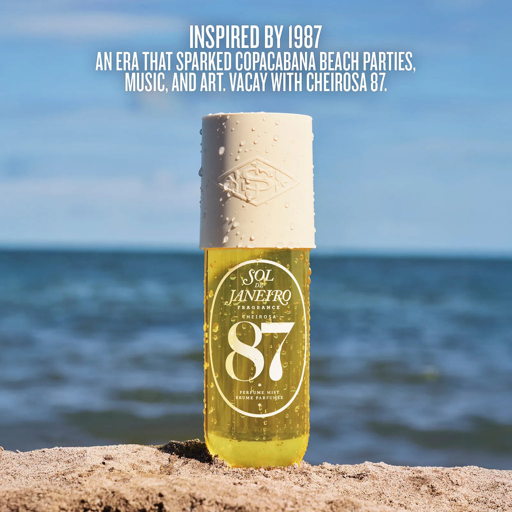 Bottle of Sol Janefro 87 on a beach with ocean view and promotional text.