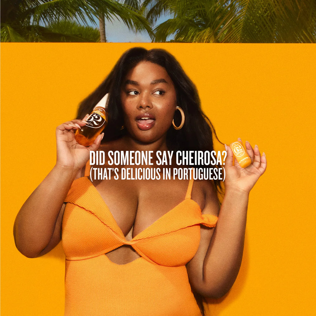 Woman in an orange dress holding two bottles against a yellow background with text.