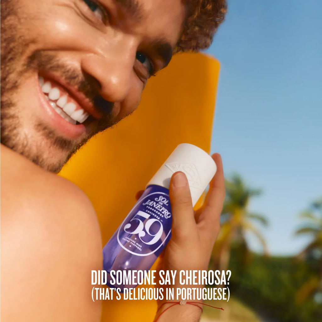 Man holding a bottle of 59 Centos with a beach background
