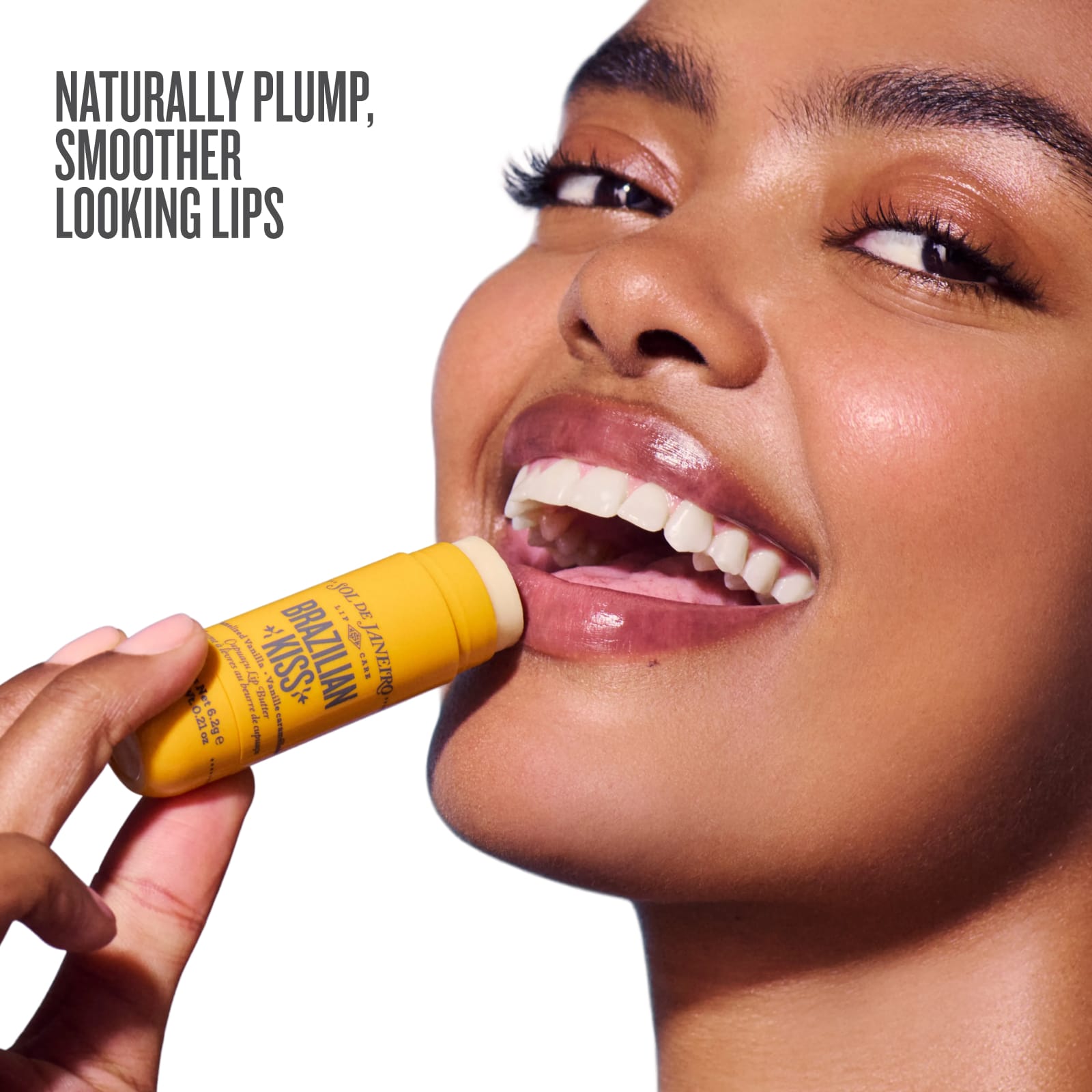 Woman applying a yellow lip balm stick with text about lips on a white background