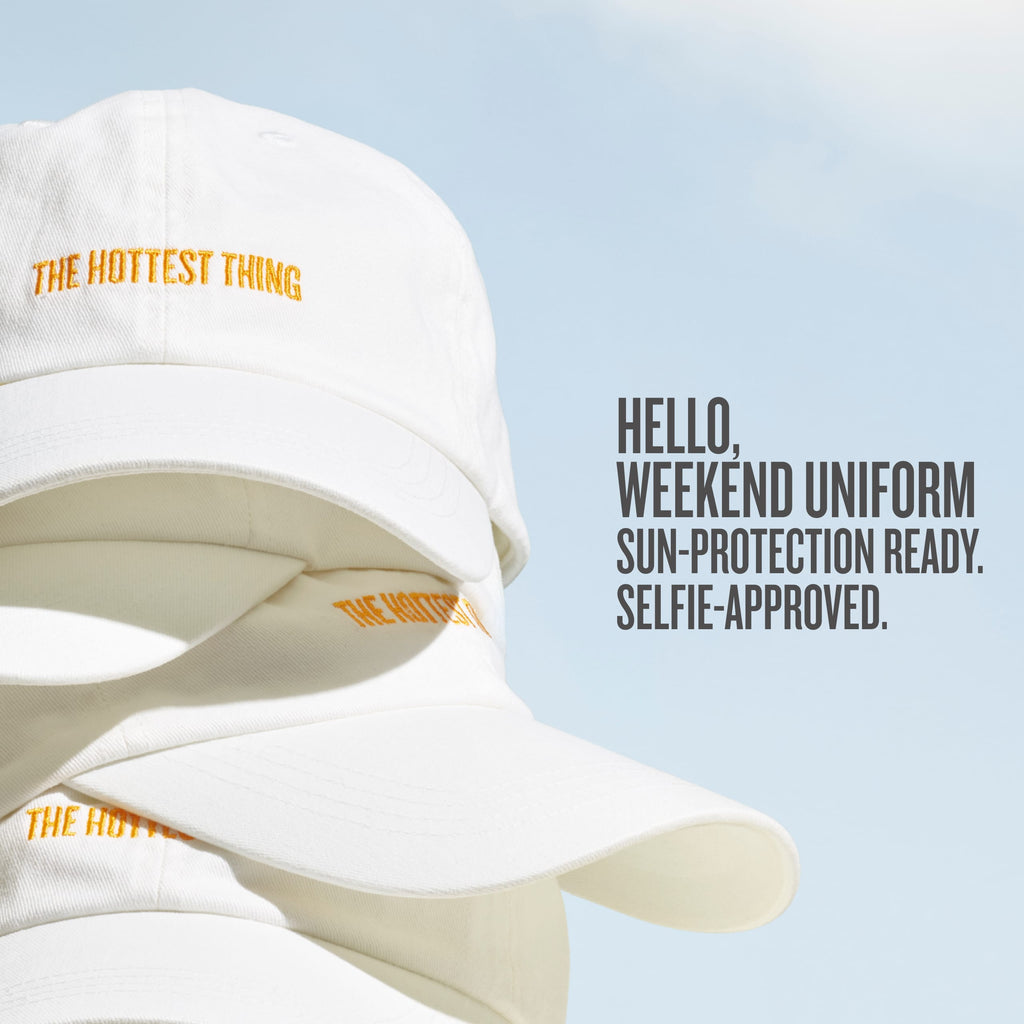 White bucket hat with yellow text on a light blue background