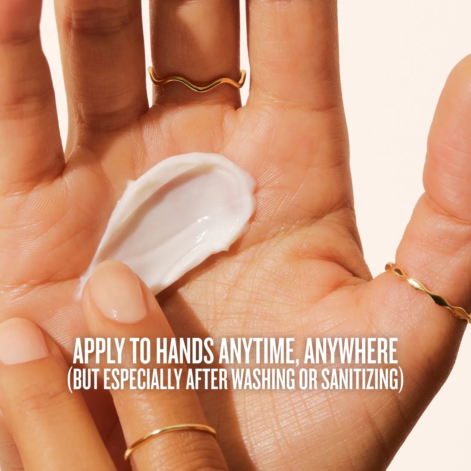 Hand applying cream with text overlay on a beige background