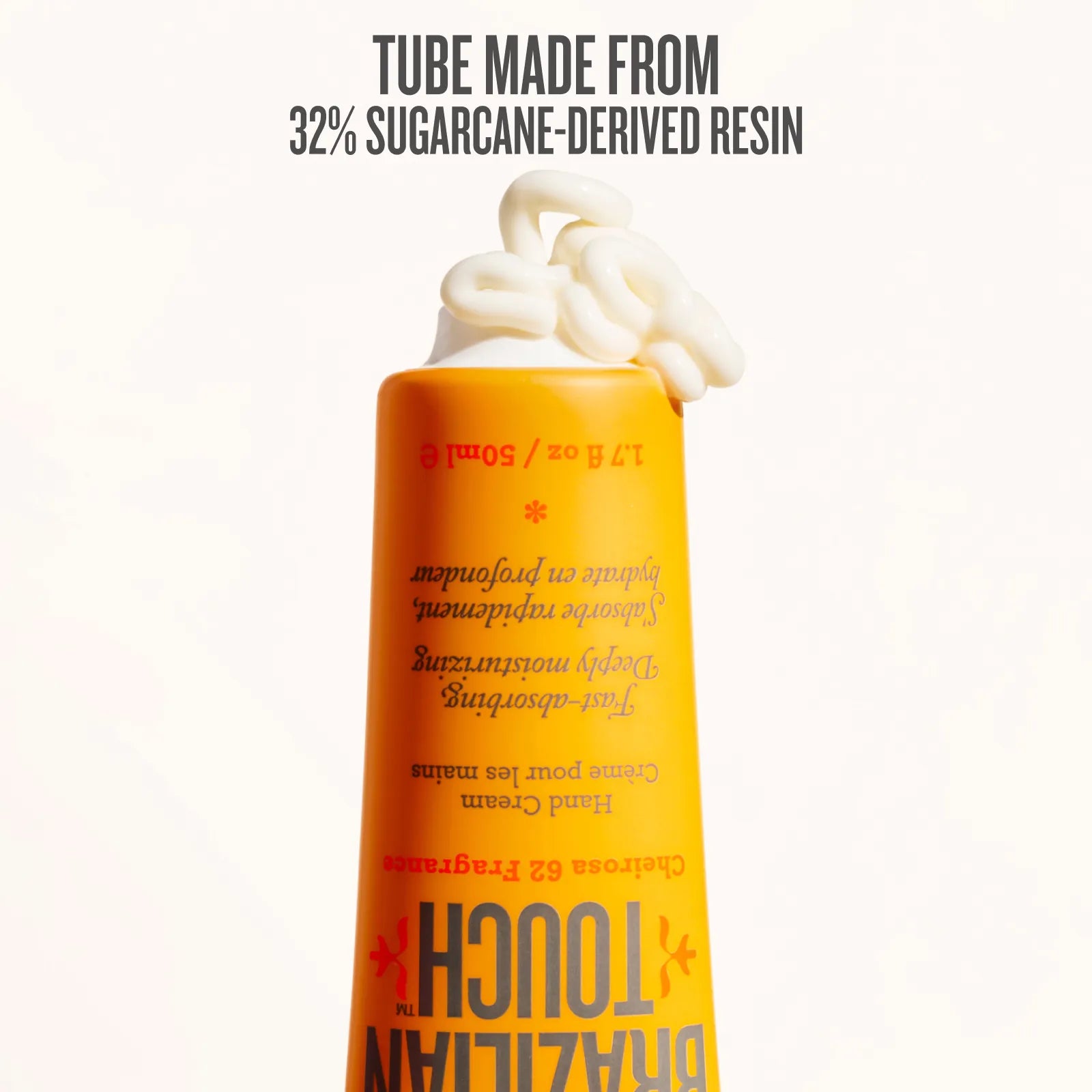 Shampoo bottle with whipped cream on a white background, featuring text about sugarcane-derived resin.