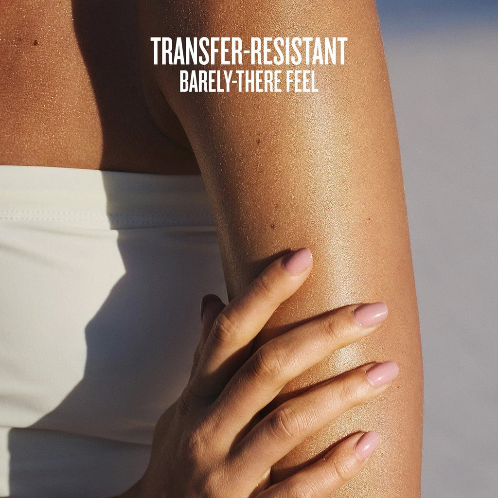 Text on image reads transfer-resistant barely-there feel. This is an image of a close up of model having the sol de janeiro glowmotions glow body oil on her arm and you can see how glowy and hydrated it makes her skin look