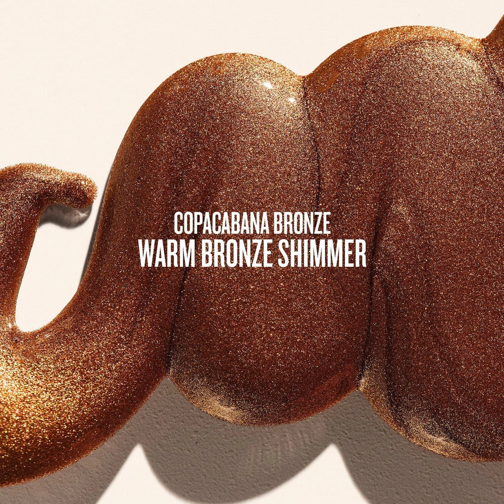 Text on image reads copacabana bronze warm bronze shimmer. This is a close up of a goop product shot of sol de janeiro glowmotions glow body oil in copacabana bronze