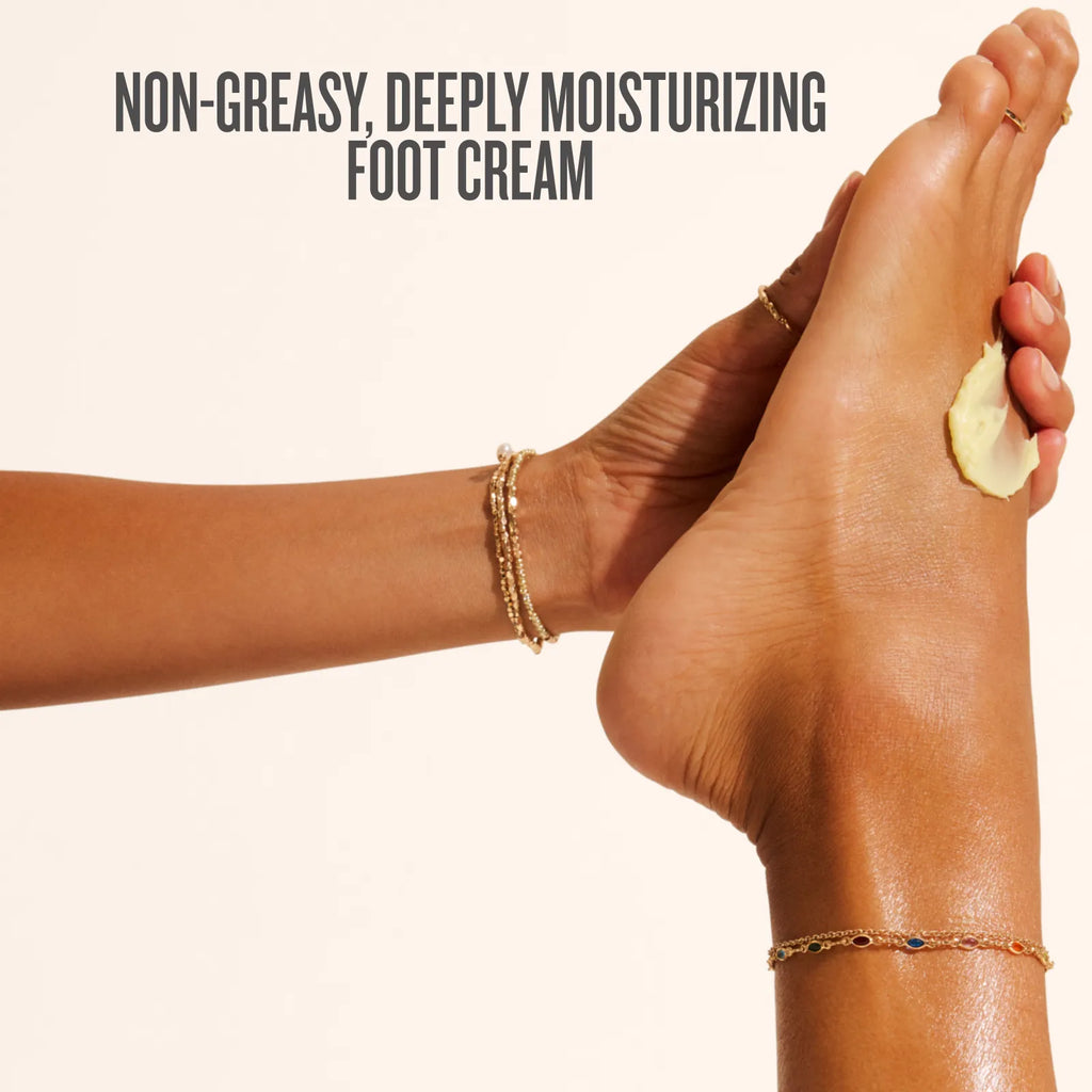 Person applying foot cream to their foot with text 'Non-greasy, deeply moisturizing foot cream' on a beige background.