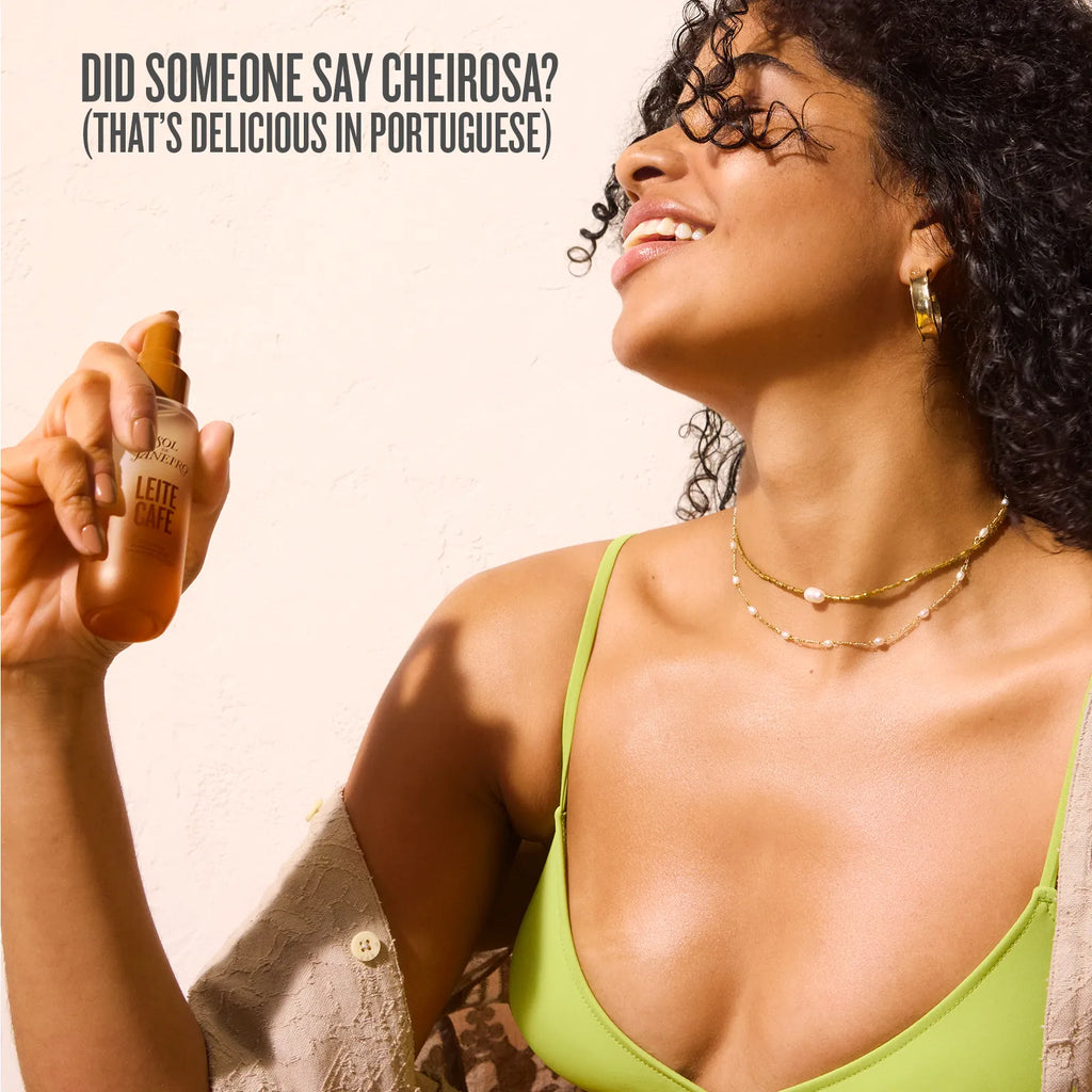 Woman holding a bottle of L'Occitane product with text about the brand name in Portuguese.