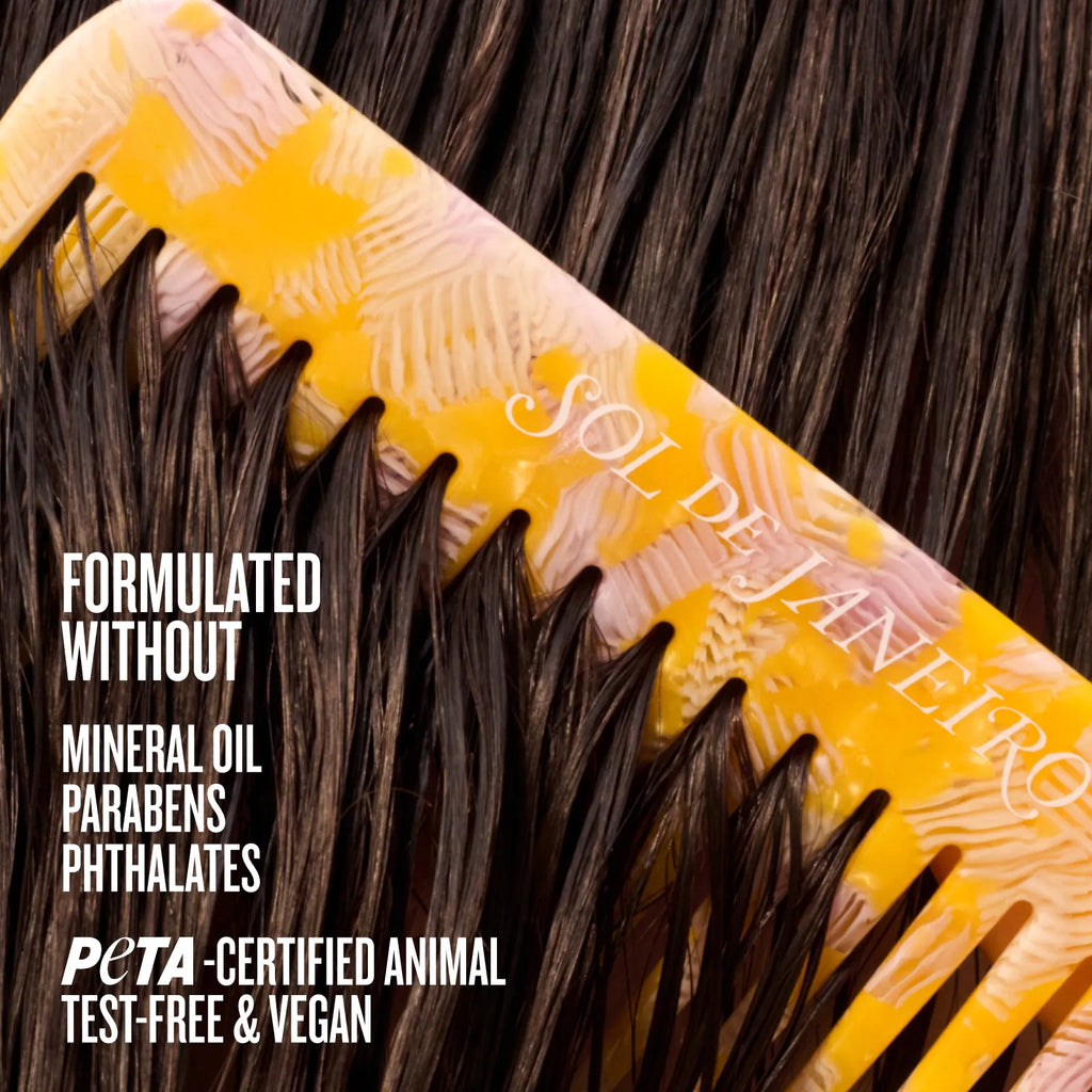 Yellow comb with brown hair being combed, featuring Sol de Janeiro branding.